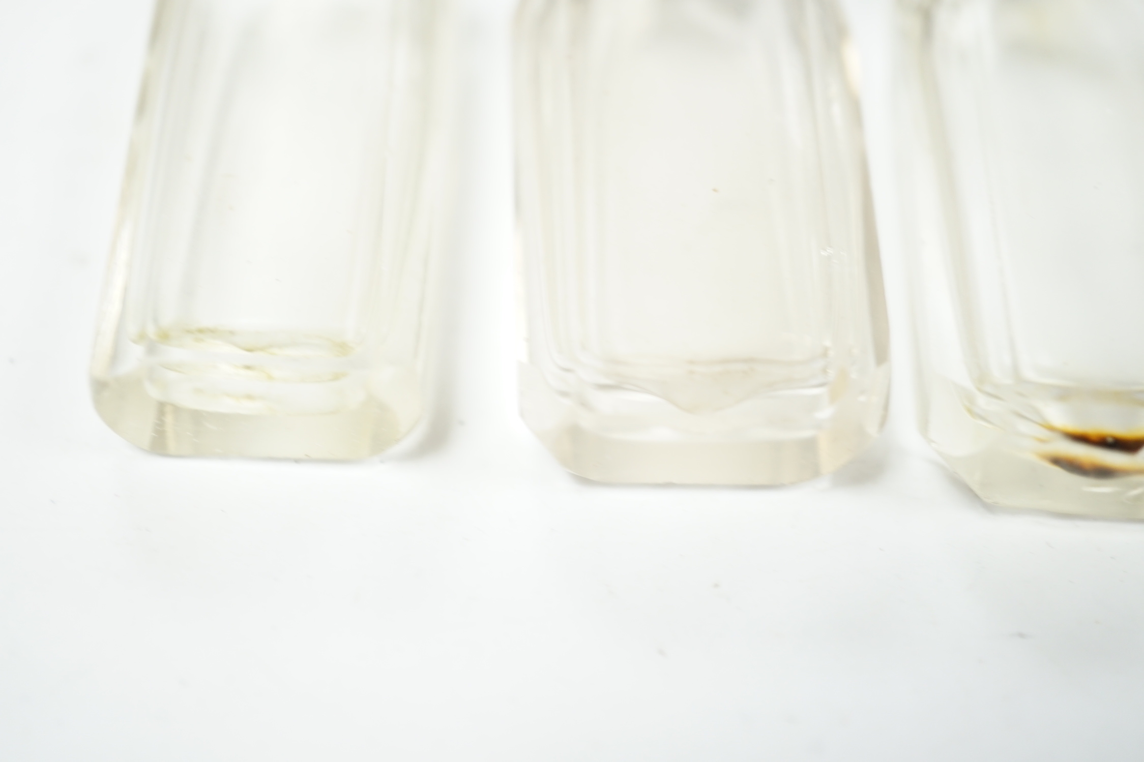 A set of four Dutch white metal mounted scent bottles, with funnel, housed in a shagreen case with hinged cover, case height 69mm.